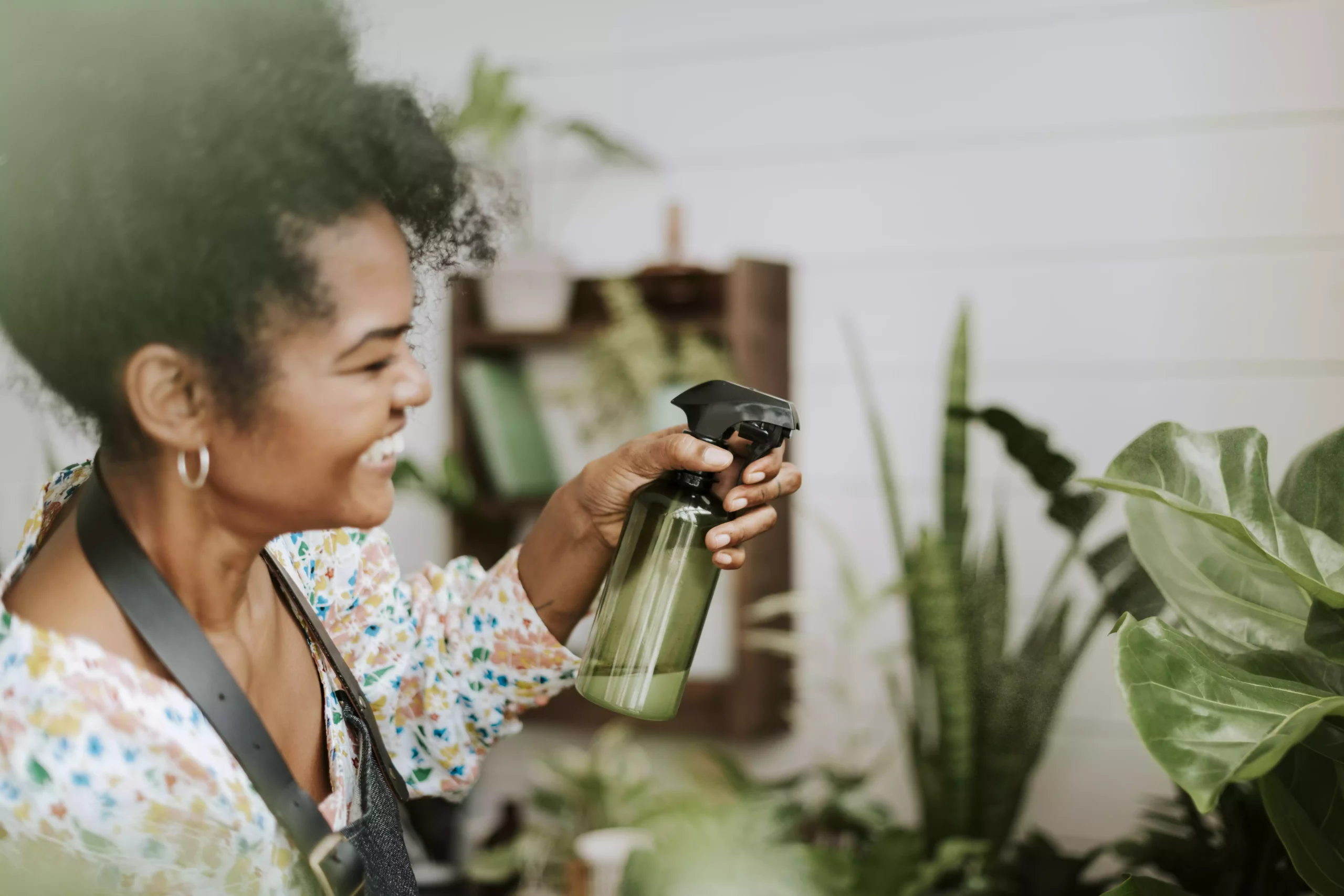 trabalhador-de-pequena-empresa-borrifando-plantas-com-spray-de-agua-min